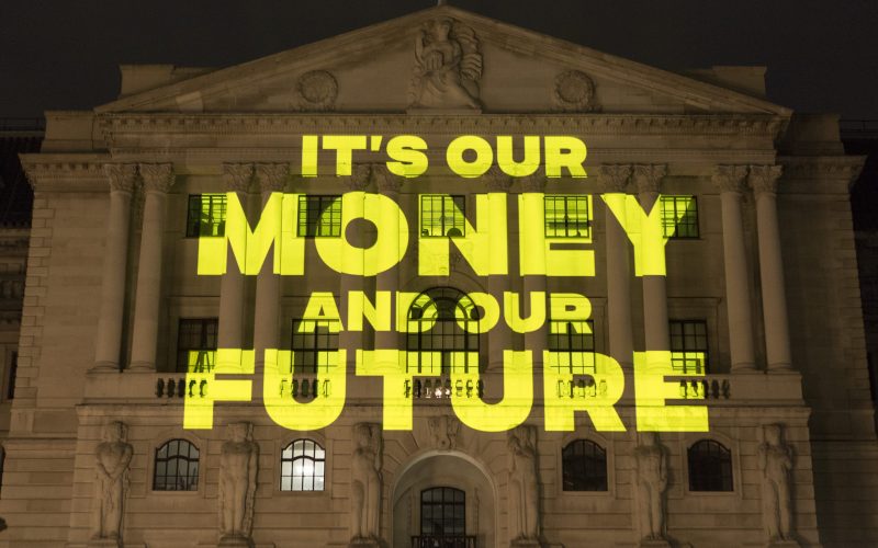 Projection on the Bank of England building reads 'It's our money and our future'